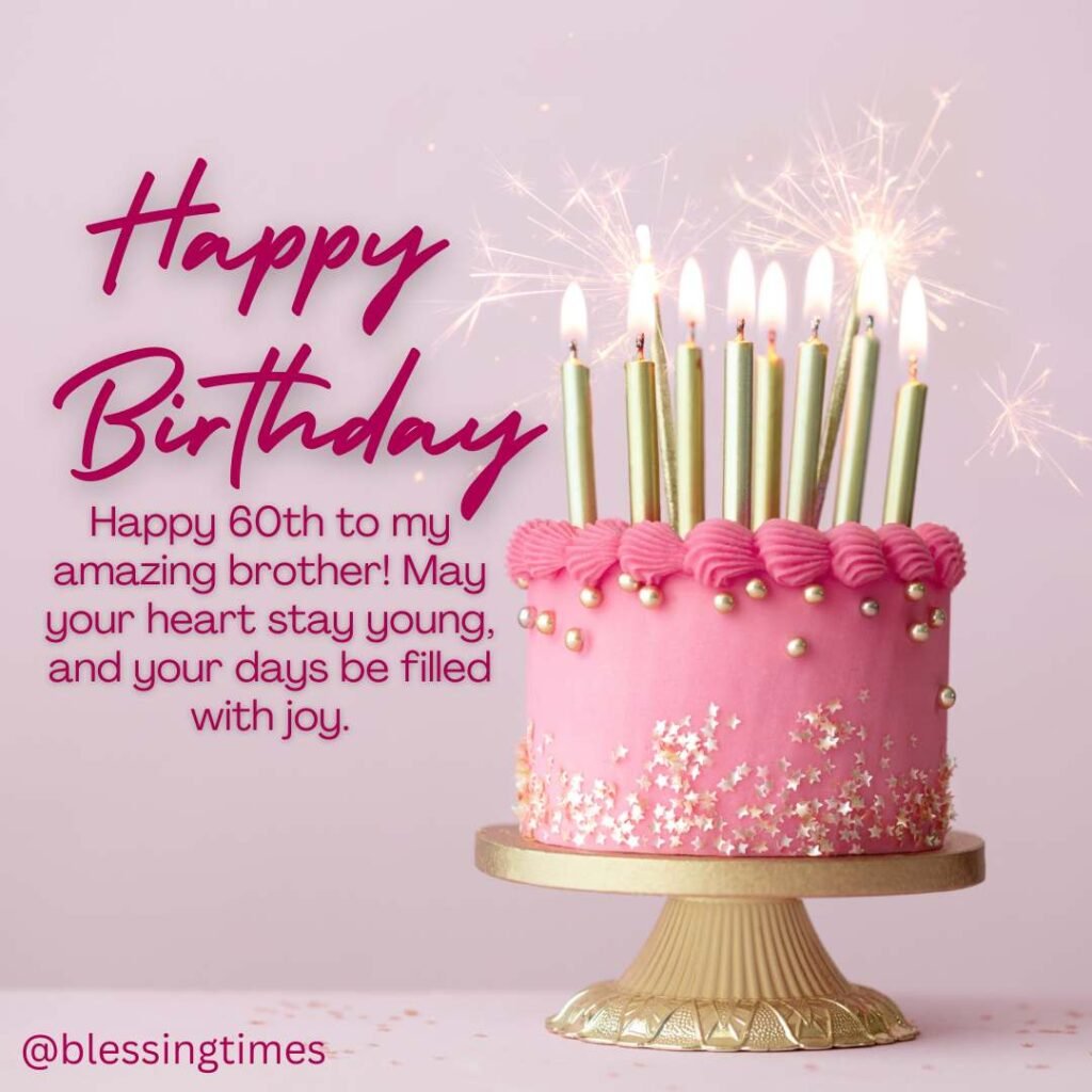 A bright pink birthday cake decorated with gold sprinkles and six tall gold candles, with sparklers in the background.